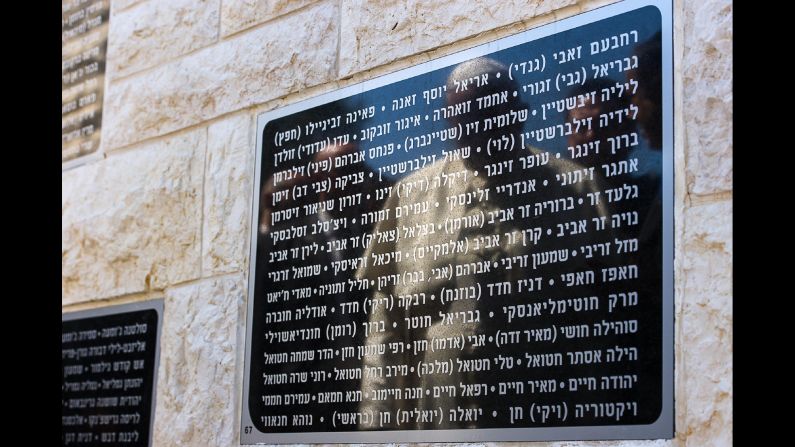 The Pope's reflection is seen May 26 on a marble plaque in Jerusalem that's engraved with names of Israeli civilians killed by terrorism.
