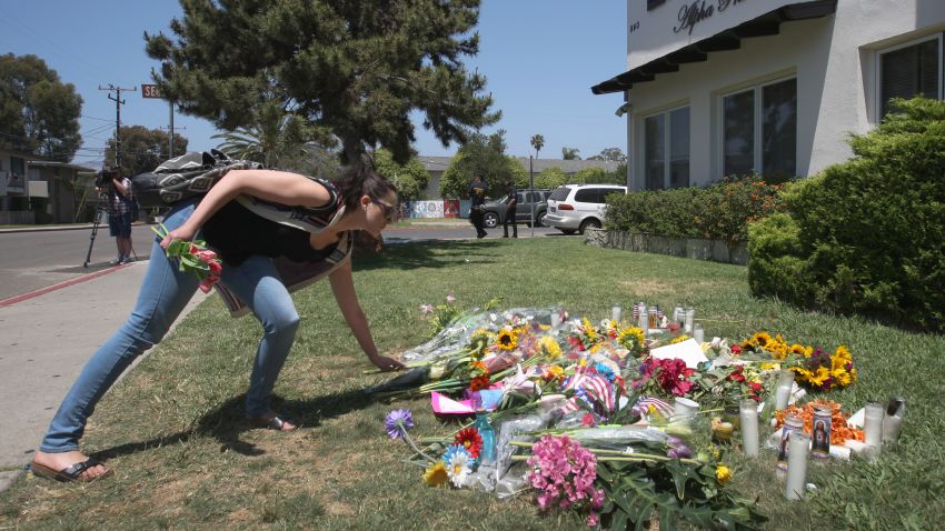 Caption:ISLA VISTA , CA - MAY 25: A woman places flowers on the lawn of the Alpha Phi sorority house May 25, 2014 in Isla Vista, California. According to reports, 22 year old Elliot Rodger, son of assistant director of the Hunger Games, Peter Rodger, began his mass killing near the University of California in Santa Babara by stabbing three people to death in an apartment. He then went on to shooting people while driving his BMW and ran down at least one person until crashing with a self-inflicted gunshot wound to the head. Officers found three legally-purchased guns registered to him inside the vehicle. Prior to the murders, Rodger posted YouTube videos declaring his intention to annihilate the girls who rejected him sexually and others in retaliation for his remaining a virgin at age 22. Seven people died, including Rodger, and seven others wounded, according to authorities. (Photo by David McNew/Getty Images)