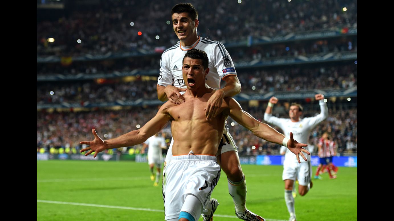 A shirtless Cristiano Ronaldo celebrates after scoring a penalty for Real Madrid in the UEFA Champions League final Saturday, May 24, in Lisbon, Portugal. Real defeated city rival Atletico Madrid 4-1, clinching a record 10th European Cup.