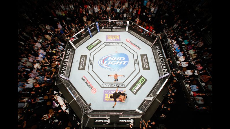 T.J. Dillashaw spreads his arms after knocking out Renan Barao in the fifth round to win the UFC bantamweight championship Saturday, May 24, in Las Vegas.