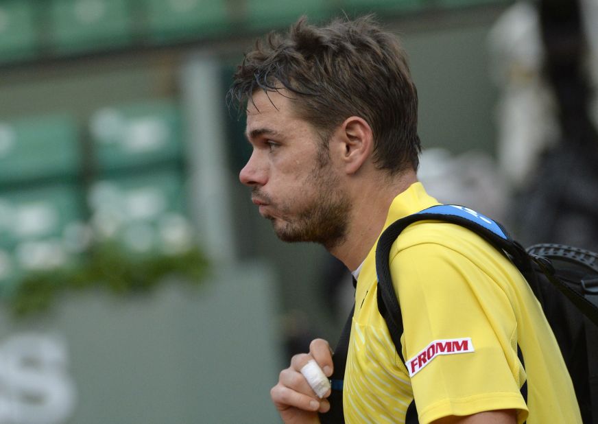 A disconsolate Stanislas Wawrinka makes his exit from Philippe Chatrier after a first round French Open defeat.