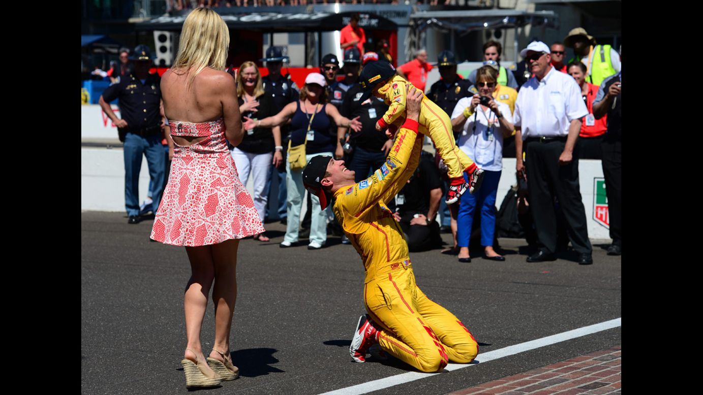 Ryan Hunter-Reay holds up his son, Ryden, at the finish line after winning the Indianapolis 500 on Sunday, May 25. His wife, Beccy, is at left. Hunter-Reay held off Helio Castroneves to win the race by .06 seconds, the second-closest finish in Indianapolis 500 history.