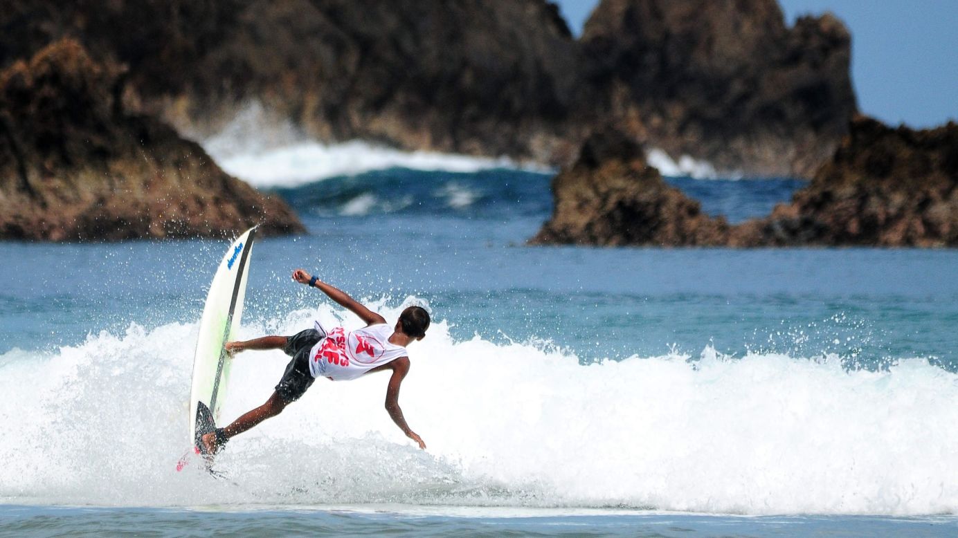 A surfer competes during the Red Island International Surfing Championship on Saturday, May 24, in Banyuwangi, Indonesia.