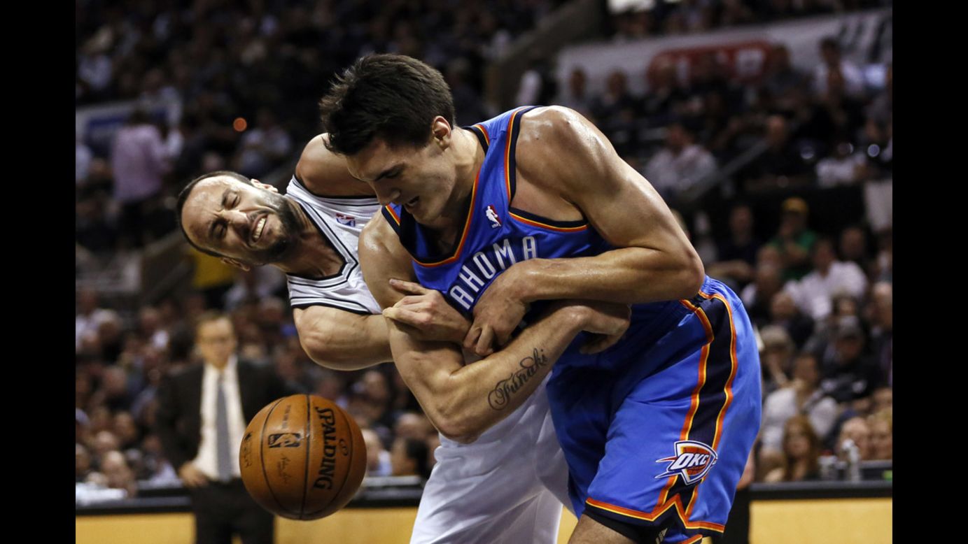 Oklahoma City Thunder center Steven Adams, right, and San Antonio Spurs guard Manu Ginobili battle for the ball in Game 2 of the NBA's Western Conference finals Wednesday, May 21, in San Antonio. The Spurs won 112-77 to take a 2-0 lead in the best-of-seven series.