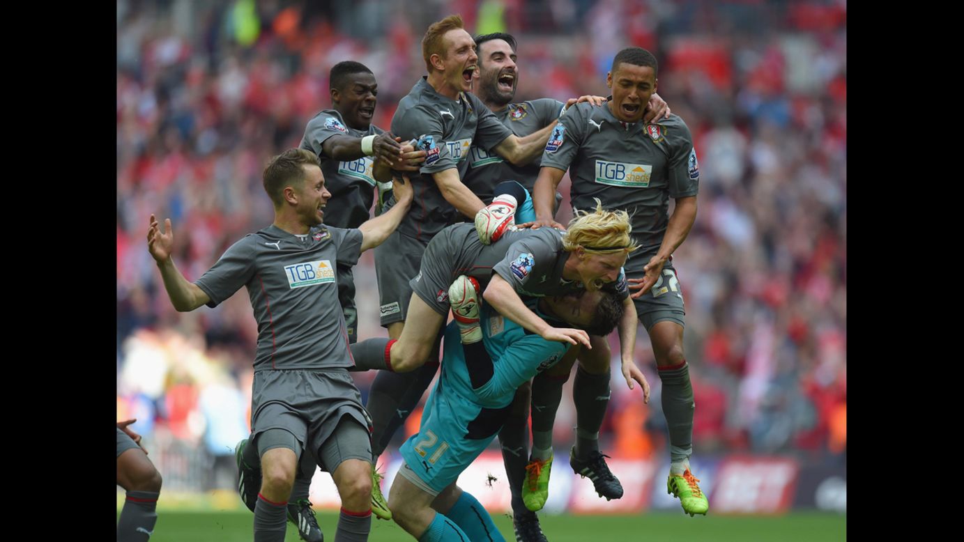 Rotherham goalkeeper Adam Collin is mobbed by his teammates after a penalty shootout victory over Leyton Orient on Sunday, May 25, in London. It was the playoff final of League One, the third division of English soccer, and Rotherham's win clinched the team's promotion into the second division.