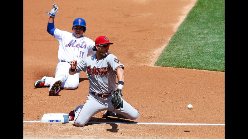 Ruben Tejada of the New York Mets slides into third base, but he is forced out by Eric Chavez of the Arizona Diamondbacks on Sunday, May 25. The two teams split a doubleheader Sunday at New York's Citi Field.