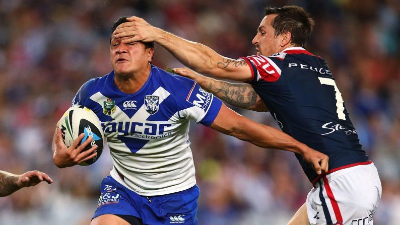 Mitchell Pearce of the Sydney Roosters tries to tackle Chase Stanley of the Canterbury-Bankstown Bulldogs during a National Rugby League match Friday, May 23, in Sydney. The Roosters won the game 32-12.
