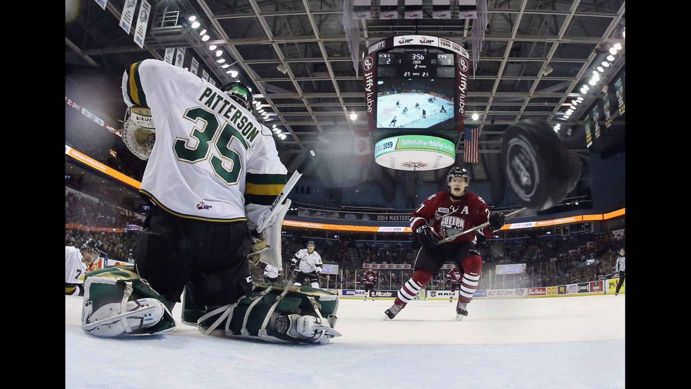 Brock McGinn of the Guelph Storm, right, watches a shot go by Jake Patterson of the London Knights during a Memorial Cup tournament game Wednesday, May 21, in London, Ontario. Guelph won the game 7-2 and advanced to the final of the tournament, which it lost 6-3 to the Edmonton Oil Kings. The Memorial Cup tournament brings together the champions of Canada's various junior hockey leagues.