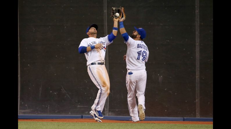 Kevin Pillar of the Toronto Blue Jays nearly collides with teammate Jose Bautista as he catches a ball during a home game against the Oakland Athletics on Friday, May 23. <a href="index.php?page=&url=http%3A%2F%2Fwww.cnn.com%2F2014%2F05%2F20%2Fworldsport%2Fgallery%2Fwhat-a-shot-0520%2Findex.html">See 36 amazing sports photos from last week</a>