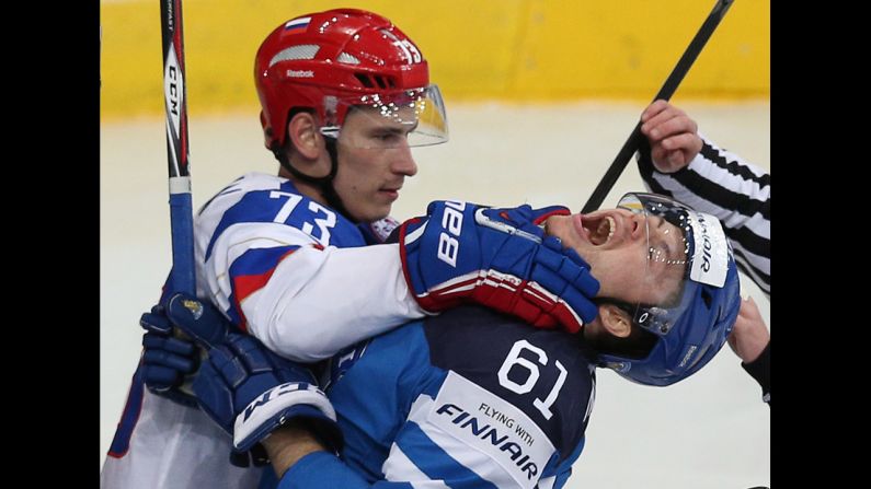Russia's Maxim Chudinov, left, scuffles with Finland's Tommi Huhtala in the final of the Ice Hockey World Championship, which took place Sunday, May 25, in Minsk, Belarus. Russia won the game 5-2 for its fifth world championship since the breakup of the Soviet Union.