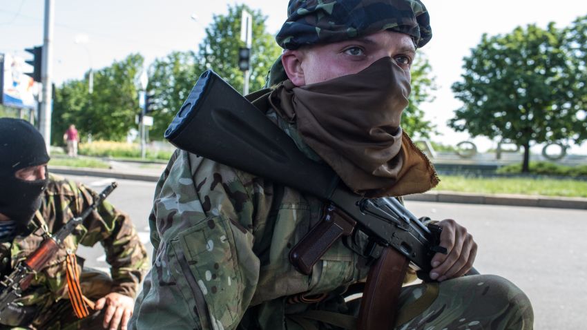 Pro-Russian separatist fighters take positions outside the Donetsk airport, the scene of an hours-long battle between pro-Russian separatists and Ukrainian forces, on May 26, 2014.