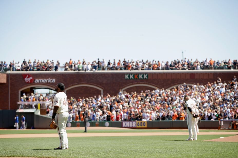 Pablo Sandoval, left, and David Huff of the San Francisco Giants stand for a moment of silence during their Memorial Day game against the Chicago Cubs at AT&T Park in San Francisco on May 26, 2014.