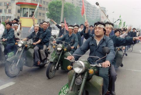May 18, 1989, Chinese workers parade on motorbikes in support of student hunger strikers. 