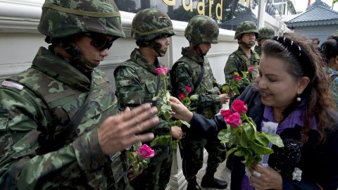 Thai soldiers receive roses from coup supporters at a military base in Bangkok on May 27. Since taking power, military authorities have summoned -- and in some cases detained -- scores of political officials and other prominent figures.