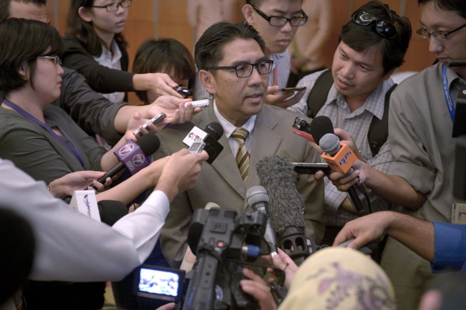 Members of the media scramble to speak with Azharuddin Abdul Rahman, director general of Malaysia's Civil Aviation Department, at a hotel in Kuala Lumpur, Malaysia, on May 27, 2014. Data from communications between satellites and the missing flight was released the day before, more than two months after relatives of passengers said they requested it be made public.