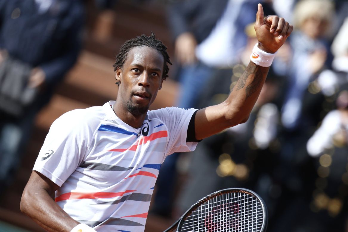 Home favorite Gael Monfils celebrates after winning his first round match against Romania's Victor Hanescu.