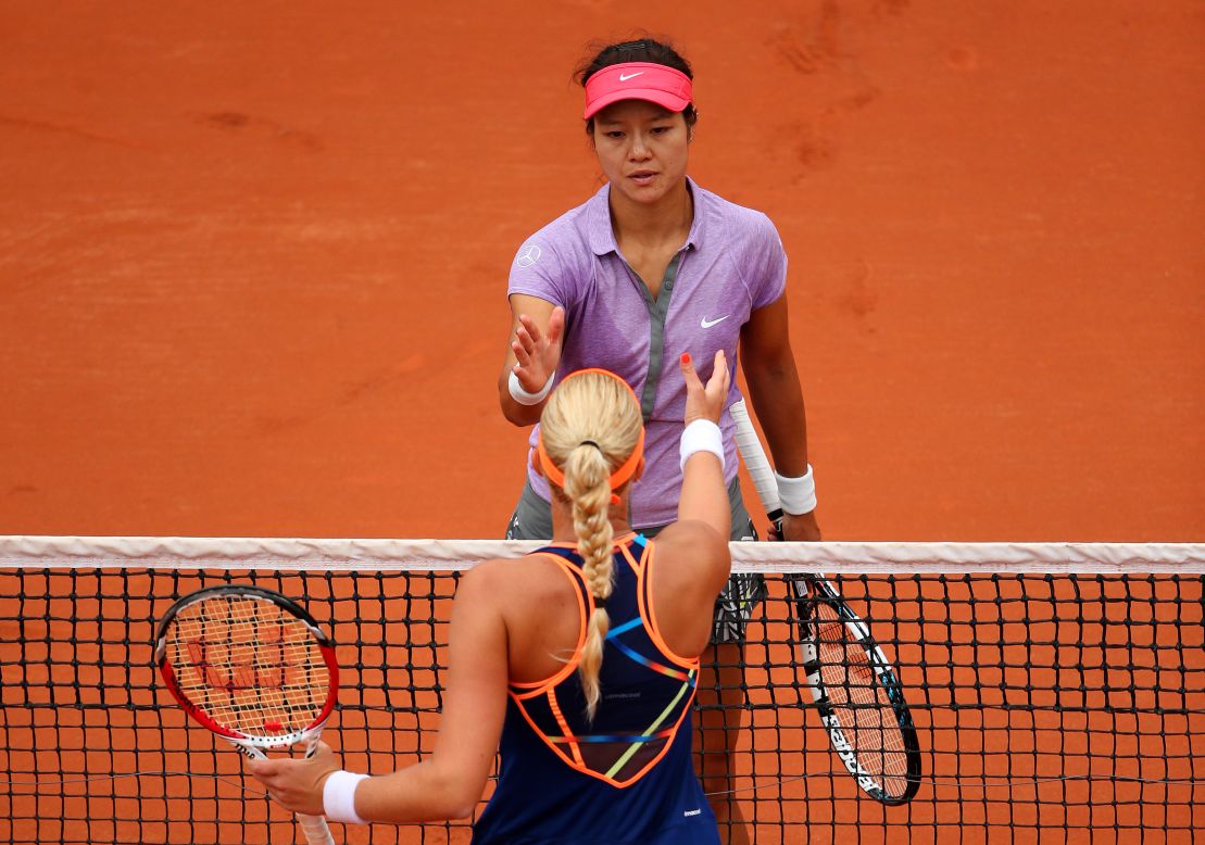 China's Li Na, French Open champion in 2011, congratulates opponent Kristina Mladenovic after being defeated by the Frenchwoman in the opening round at Roland Garros.