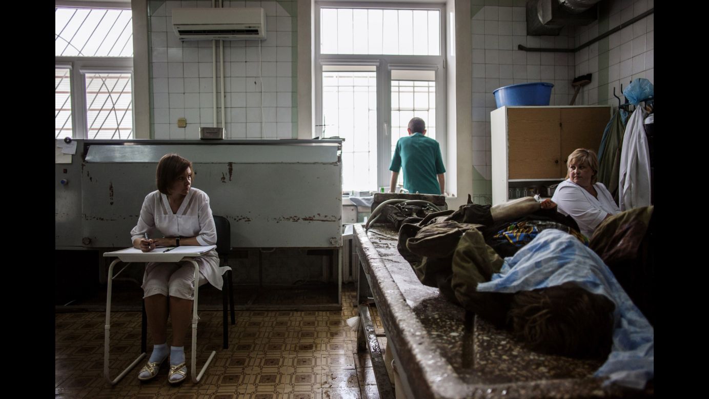 Medical staff prepare to clean the body of a pro-Russian militant at the Kalinina morgue in Donetsk on May 27.