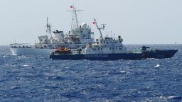 A Chinese coast guard ship (back) shadows a Vietnamese coast guard vessel near the Paracel Islands on May 14.