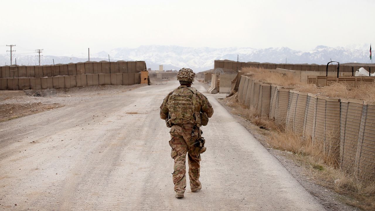 PUL-E ALAM, AFGHANISTAN - MARCH 27: U.S. Army SPC Romik Hazarian escorts U.S. Army advisers with 2nd Battalion 87th Infantry Regiment, 3rd Brigade, 10th Mountain Division inside Forward Operating Base (FOB) Maiwand, an Afghan National Army (ANA) base that adjoins the U.S. Army's FOB Shank, on March 27, 2014 near Pul-e Alam, Afghanistan. Soldiers with the U.S. Army's 3rd Brigade Combat Team, 10th Mountain Division stationed at FOB Shank advise and assist Afghan National Security Forces in the region. Security is at a heightened state throughout Afghanistan as the nation prepares for the April 5th presidential election. (Photo by Scott Olson/Getty Images)