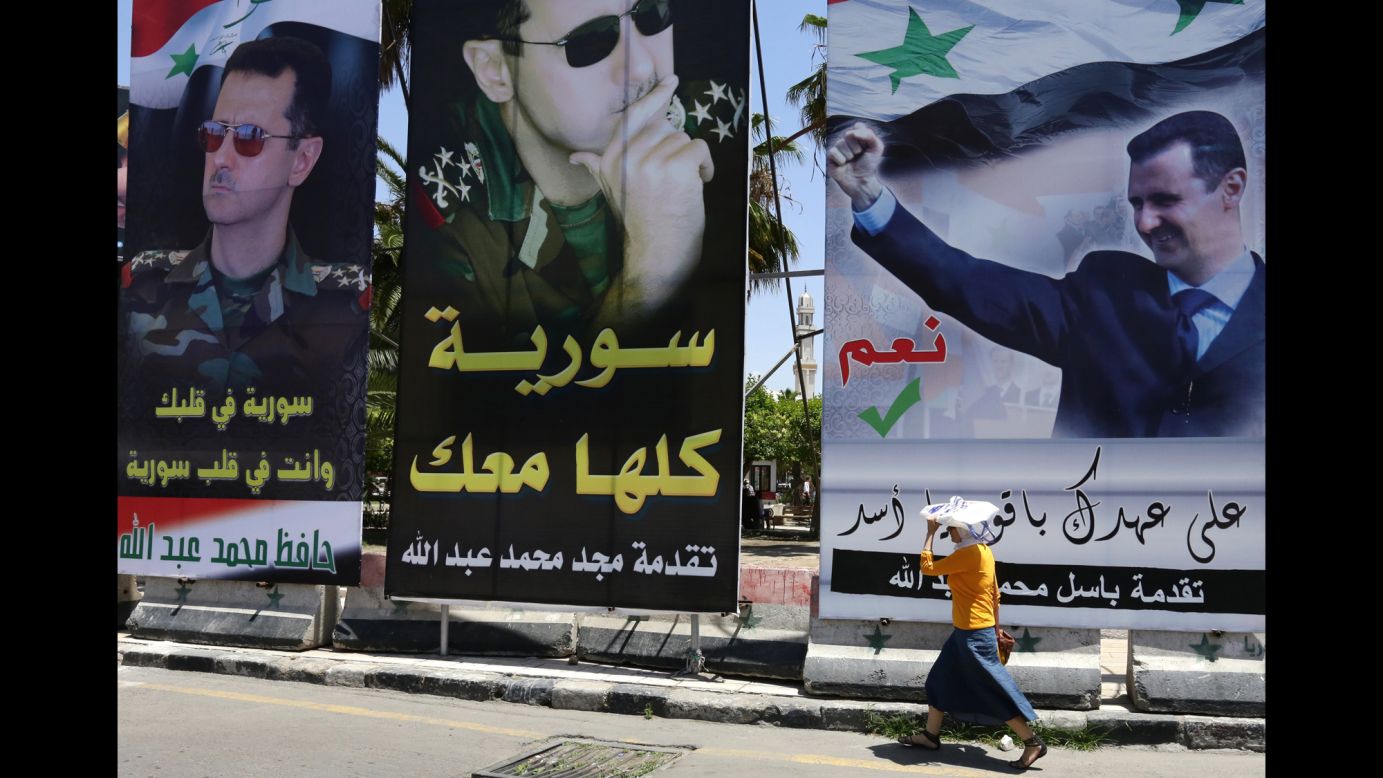 Portraits of al-Assad dominate the cityscape in central Damascus on Tuesday, May 27. Al-Assad is firmly in power three years into the civil war, while the opposition remains weak and fragmented and extremists grow in numbers and influence.