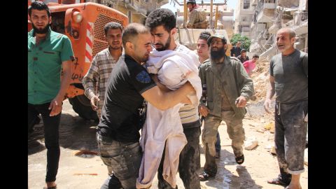 The father of a 3-month-old girl weeps Monday, May 26, after she was pulled from rubble following a barrel-bomb strike in Aleppo.