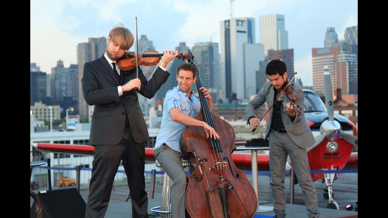 Nick Kendall, Ranaan Meyer and Zachary DePue of Time for Three perform at the inaugural exhibit of vintage Breguet timepieces on board the USS Intrepid on June 14, 2012 in New York City.  