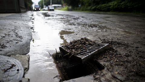 [File] An open sewage drain following heavy rains in Visé on June 21, 2013.