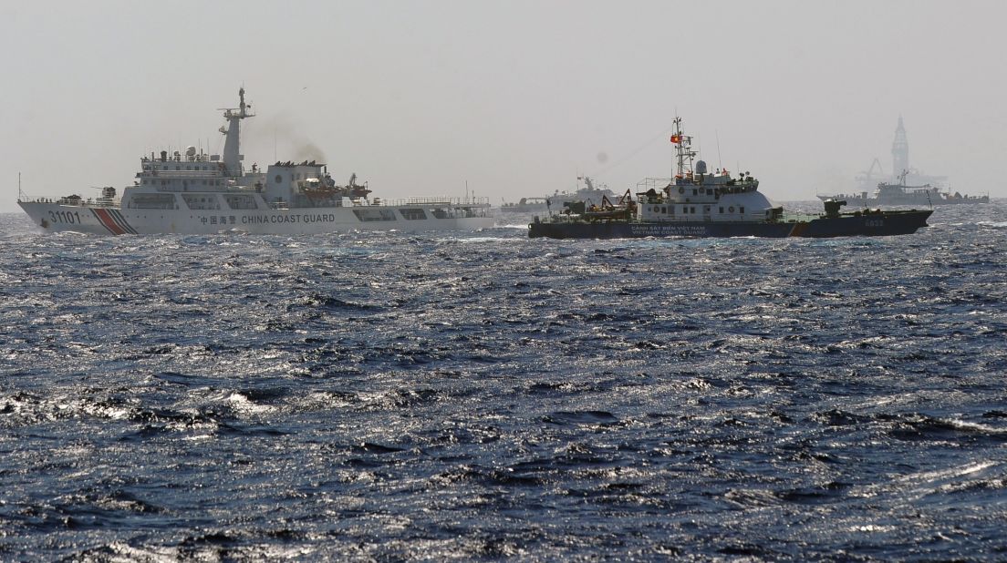 A Vietnamese Coast Guard ship (second right, dark blue) tries to make way amongst several China Coast Guard ships near a Chinese drilling oil rig (right background) being installed in disputed waters in the South China Sea on May 14.