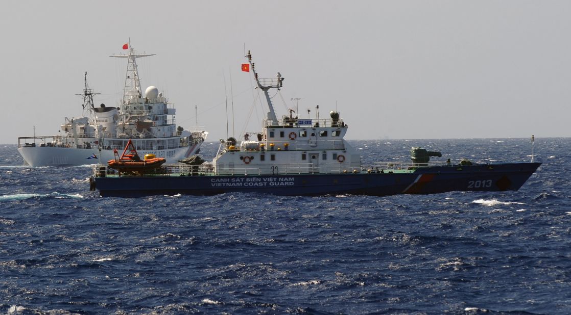 A China Coast Guard ship (left) follows a Vietnamese Coast Guard vessel (right) near the site of the oil rig on May 14.
