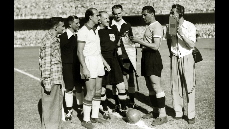 With a Brazilian radio reporter nearby, team captains August, left, of Brazil and Obdulio Varela of Uruguay exchange pennants before the decisive match of the tournament. Going into the match, Brazil only needed a draw to secure the title. Uruguay had to win.