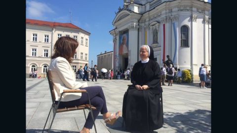 Paula Newton and Sister Benedykta Mazur sit outside Wadowice Basilica