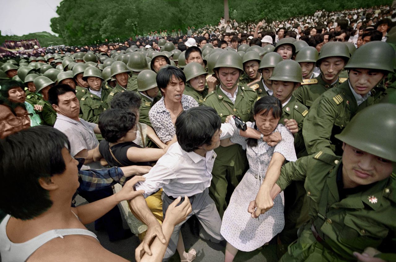 "I'm not an activist. I'm not a hero," Widener said in 2014. "But I'm human, and it is hard not to be sympathetic towards anybody who was killed." Here, a young woman is caught between civilians and Chinese soldiers who were trying to remove her from an assembly near the Great Hall of the People on June 3, 1989. "I never actually saw any protesters killed," Widener said. "I saw soldiers killed. Mistakes were made on both sides. It's important to look at both sides of the story."