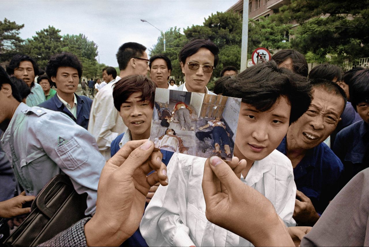 After the crackdown, people show a picture of protesters' bodies at a morgue.