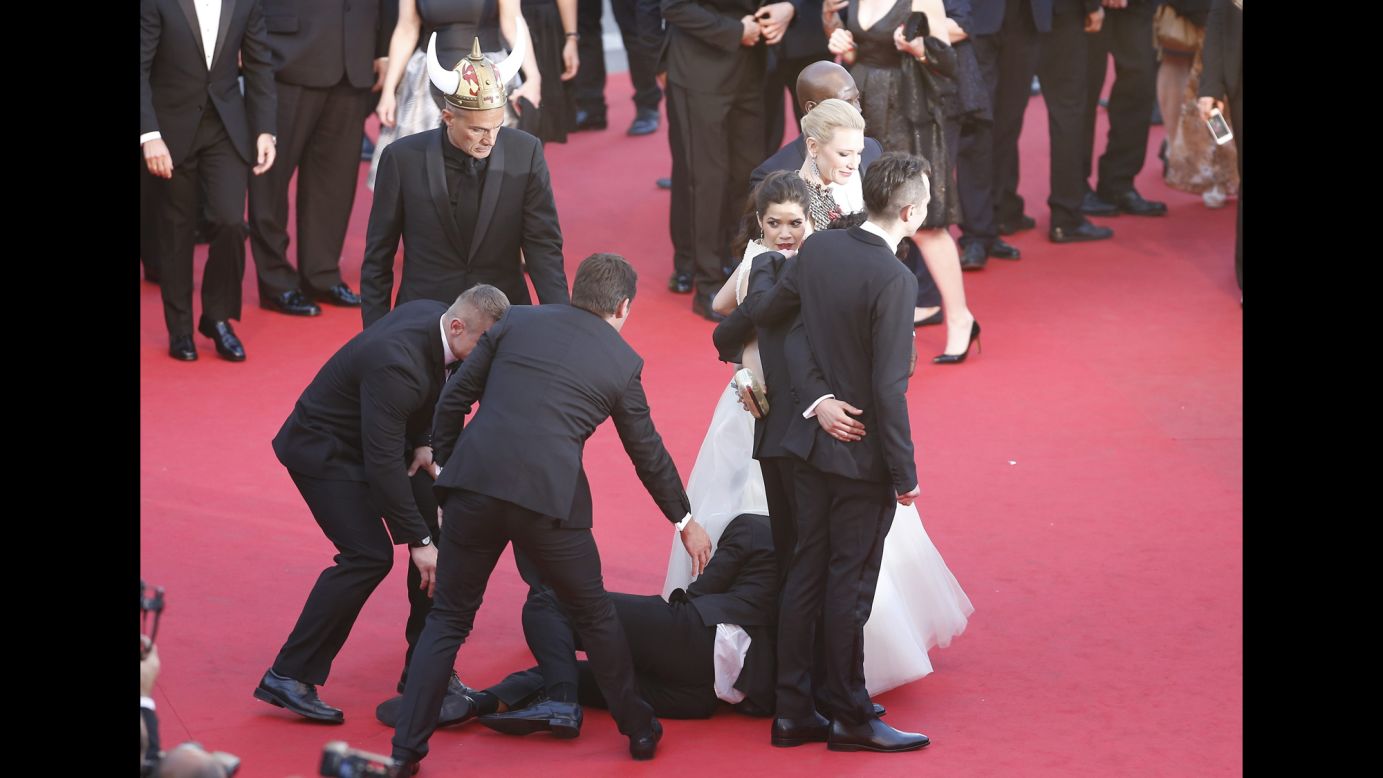 Security guards quickly pull Sediuk away from under the dress of actress America Ferrera on the red carpet at the 2014 Cannes Film Festival in France on May 16.