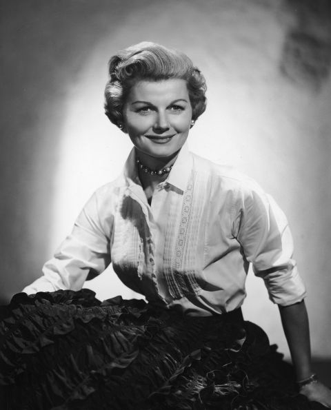 Barbara Billingsley wears pearls and a white blouse with lace stitching, her usual attire as mother and housewife June Cleaver in the 1950s show "Leave it to Beaver." Female characters in '60s TV moved beyond big skirts and heels into more adventurous territory.