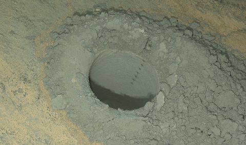 Curiosity took this nighttime photo of a hole it drilled May 5 to collect soil samples. NASA said this image combines eight exposures taken after dark on May 13.