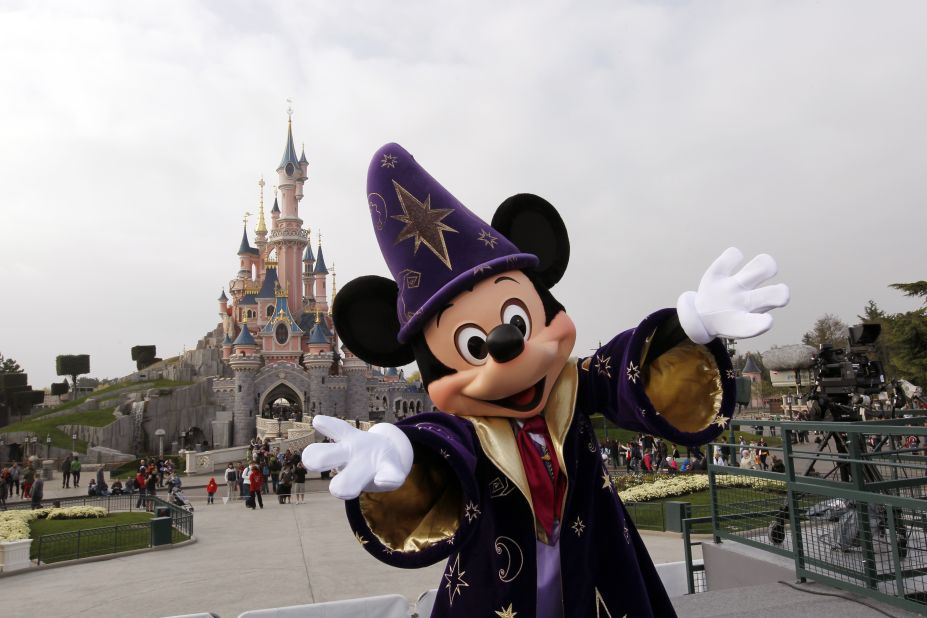 6. Mickey Mouse poses in front of the Sleeping Beauty Castle at the Disneyland park outside of Paris.