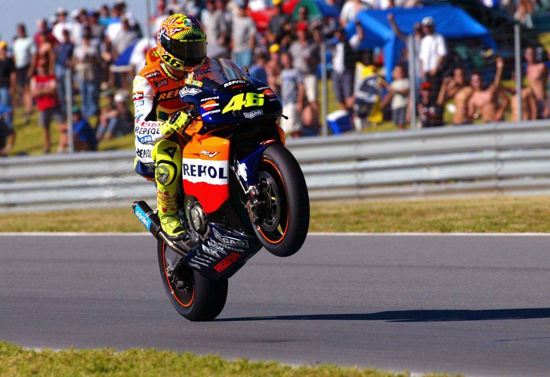 Rossi performs a wheelie after taking pole position on his Honda at the MotoGP in South Africa in 2002.