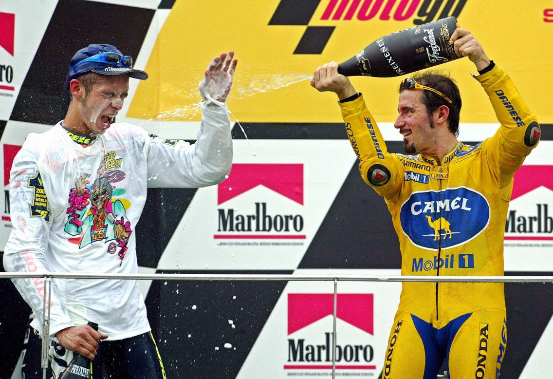 Rossi is on the receiving end of the champagne as compatriot Max Biaggi toasts him after wrapping up a third straight world title in Malaysia in 2003.