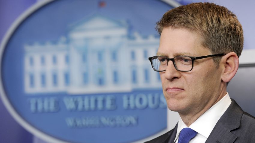 White House press secretary Jay Carney listens as President Barack Obama announces that Carney is leaving, Friday, May 30.