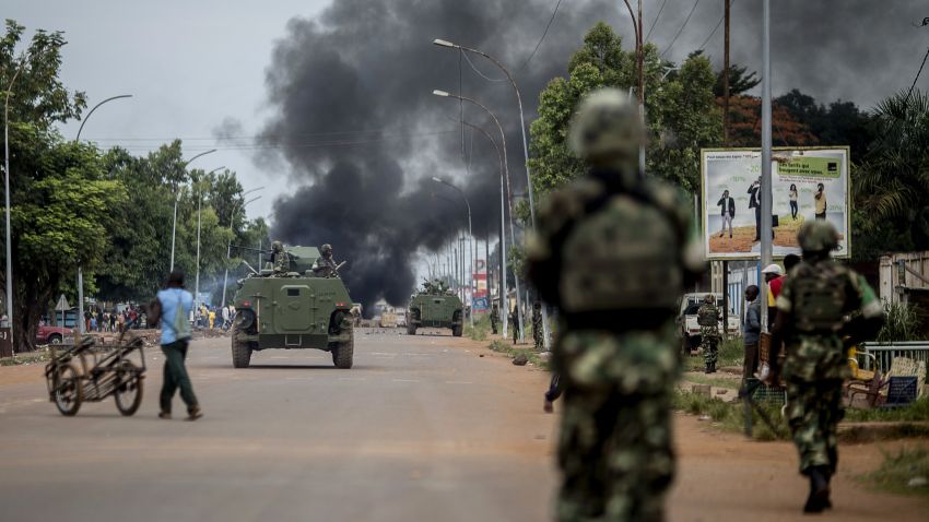 Burundian peacekeepers of the African-led International Support Mission to the Central African Republic (MISCA) patrol near a barricade of burning tyres in the Bea-Rex district of Bangui on May 29, 2014.