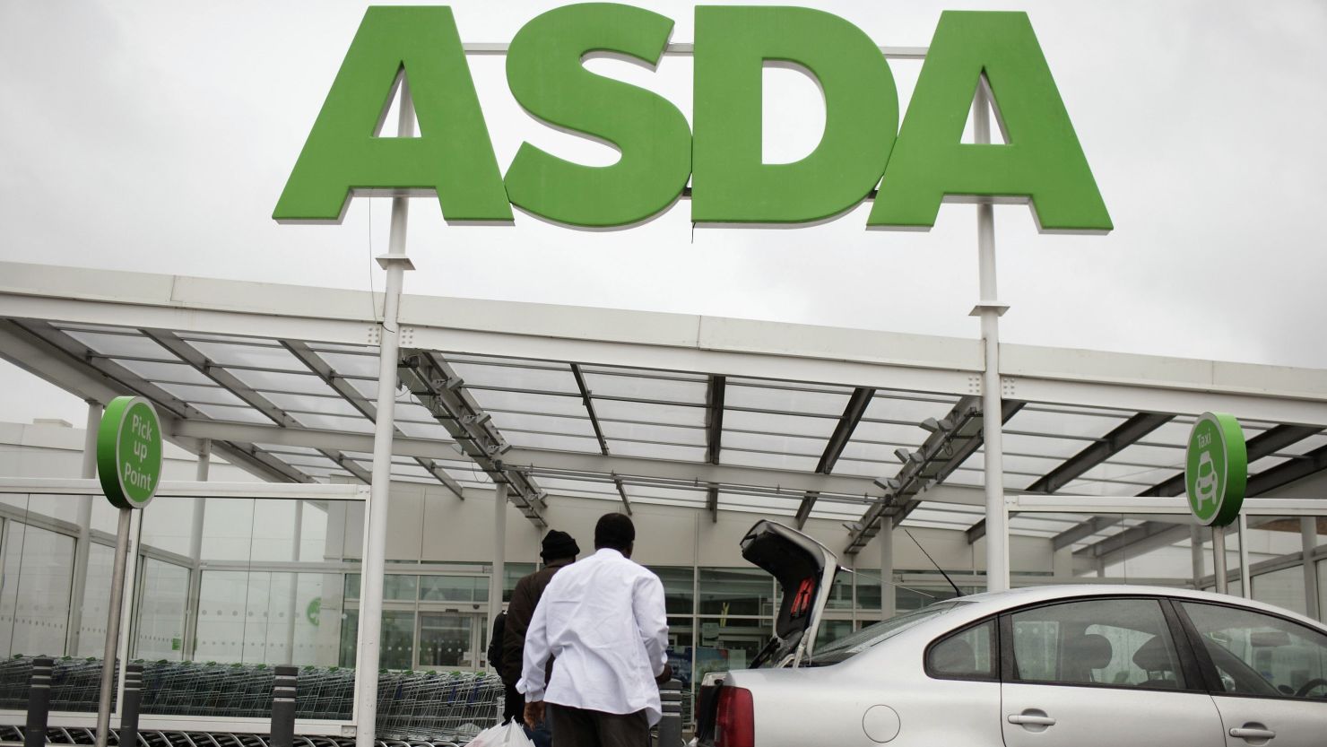 Customers enter an ASDA store in London, England.
