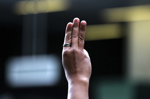 A protester holds up three fingers during an anti-coup demonstration at a Bangkok shopping mall on June 1.