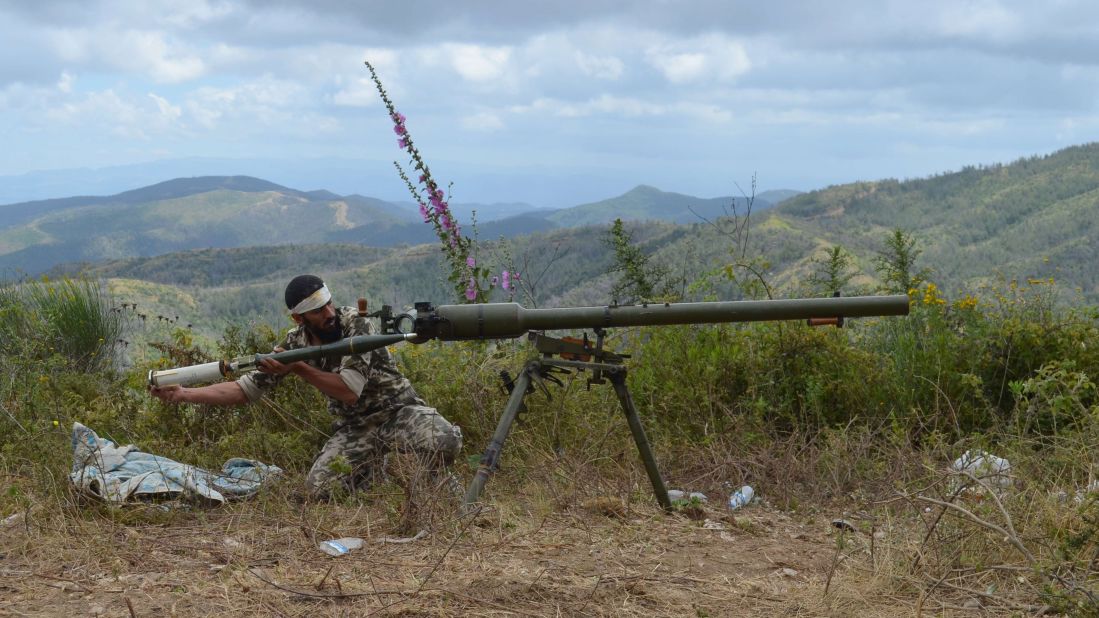 A rebel fighter loads an anti-tank cannon outside Latakia, Syria, on Sunday, June 1.