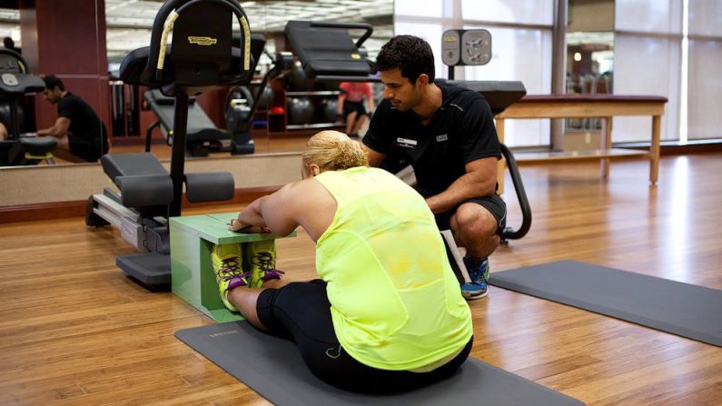 Manns reaches forward during a stretch test at the gym. She's had two hip replacements, but says she's "<a href="http://www.cnn.com/2014/03/14/health/fit-nation-karen-hips/">too young not to run.</a>"