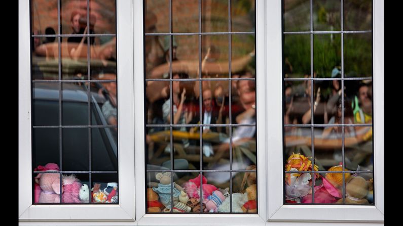 Reporters and television crews are reflected in the playroom window of the McCann family home in Rothley, England, in September 2007.