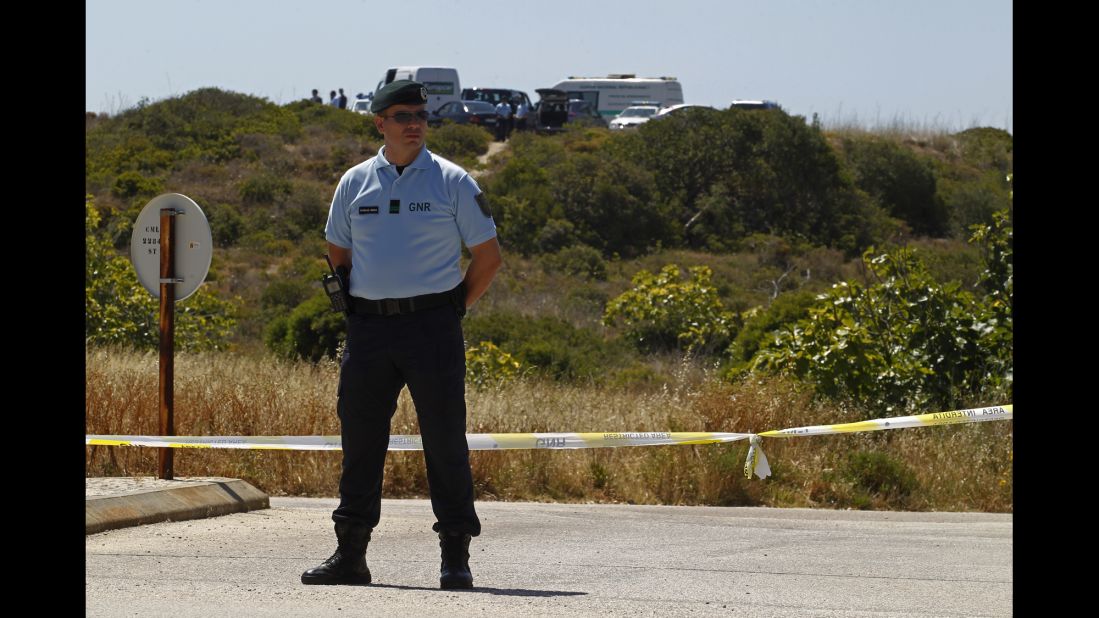 A Portuguese Republican Guard policeman stands guard as police begin digging in an area of wasteland near Praia da Luz on June 2, 2014.