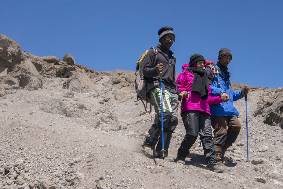 Some climbers suffer from altitude sickness or exhaustion and have to be supported down the mountain, hand in hand, by their guides.