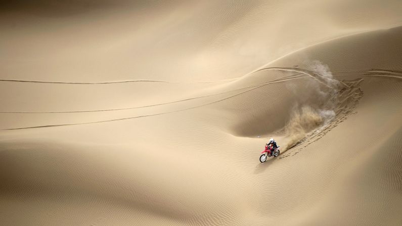 Wang Yirong rides his motorcycle through a desert in China's Xinjiang Uyghur Autonomous Region as he competes in the China Taklimakan Rally on Saturday, May 31.